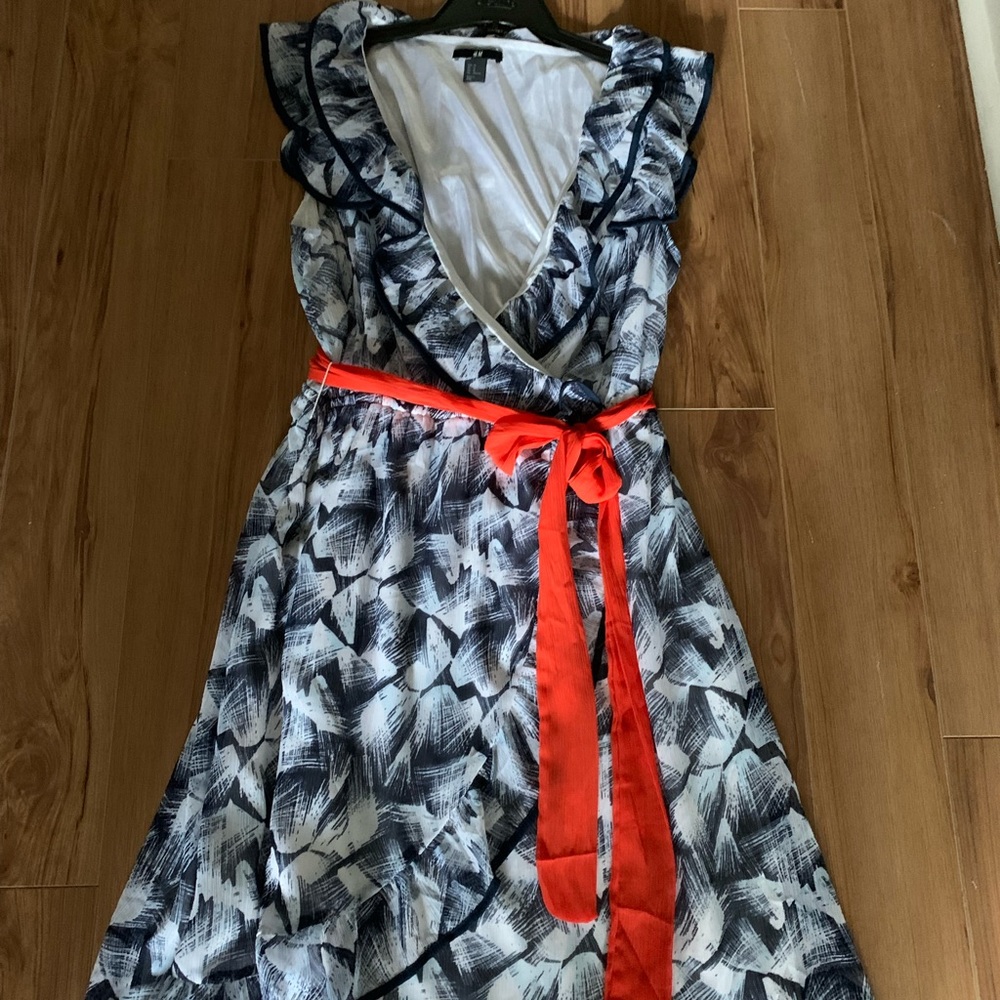 H&M flowy white and navy print dress with deep v neck and red sash.